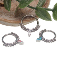 Beaded titanium teardrop clicker ring 16g body jewelry with intricate bead details and smooth curved design.