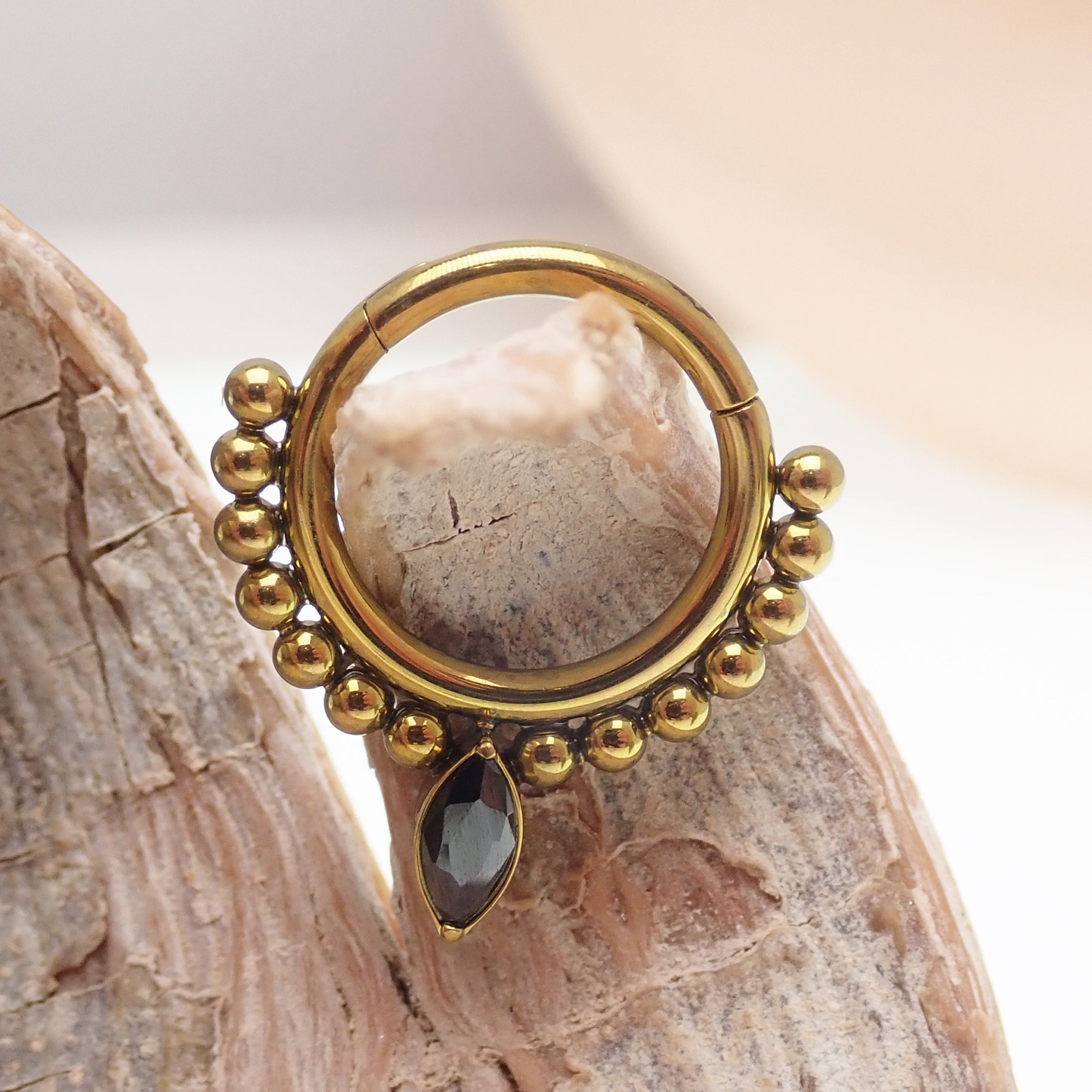 Gold and black beaded titanium teardrop clicker ring for body jewelry, 16 gauge, by Body Clickers.