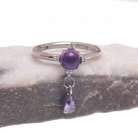 Implant grade titanium amethyst hinge clicker body jewelry in 16g with 8mm or 10mm size, featuring a stylish purple gemstone design.
