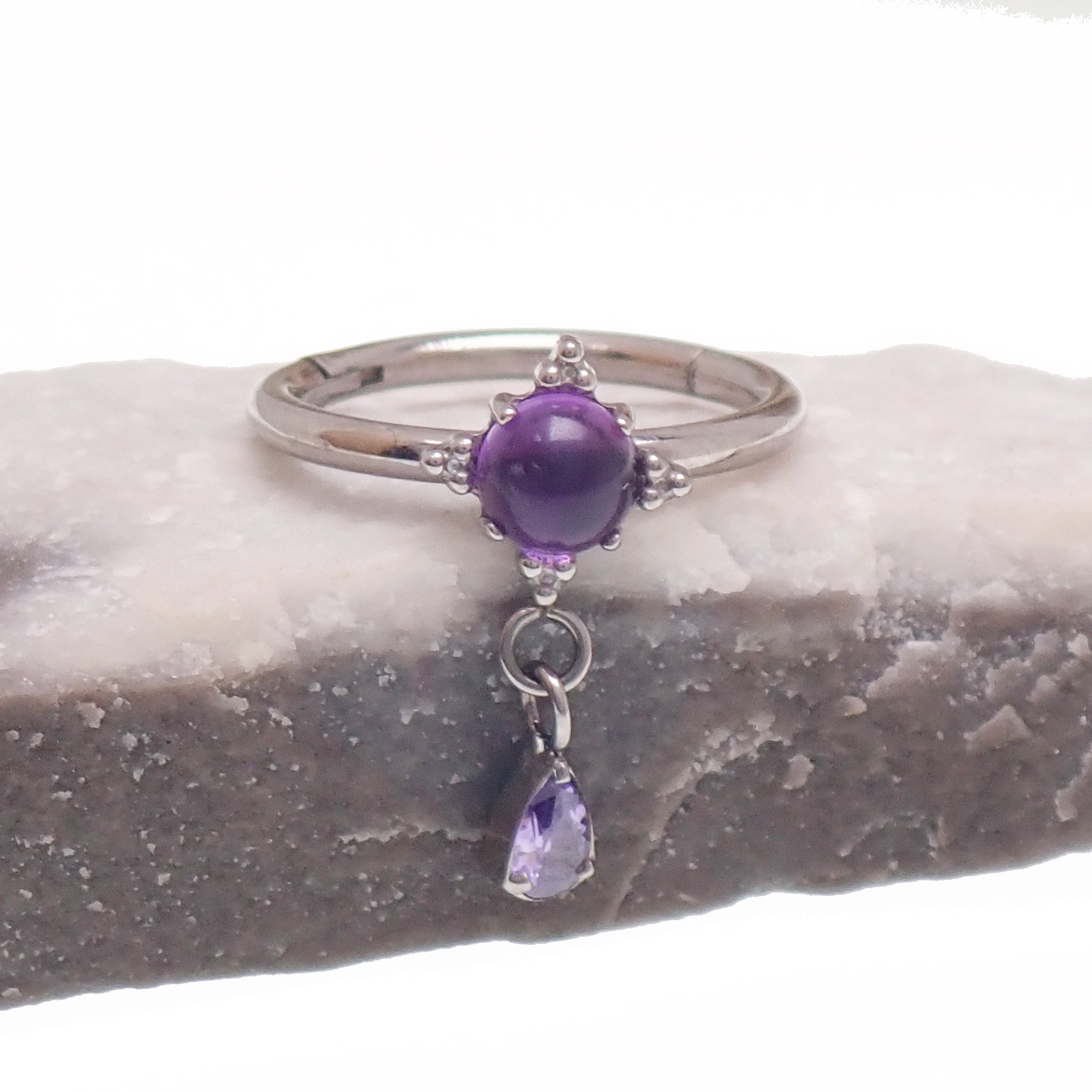 Implant grade titanium amethyst hinge clicker body jewelry in 16g with 8mm or 10mm size, featuring a stylish purple gemstone design.
